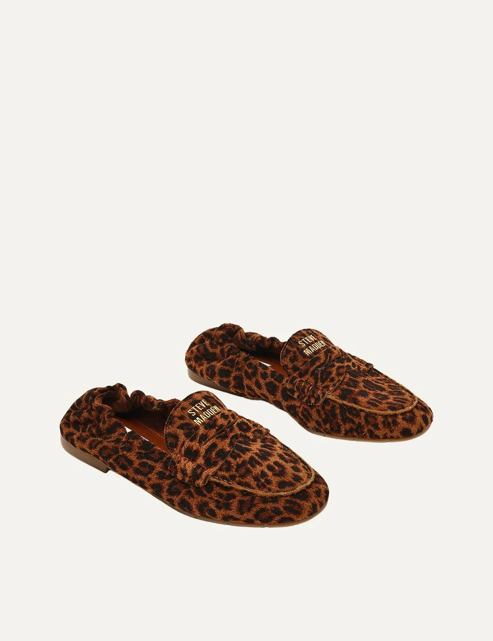 Steve Madden women's leopard print suede loafers in brown and black with decorative penny strap, gold tone metal detail, gathered heel, rounded toe and flat brown sole, pair front angle view