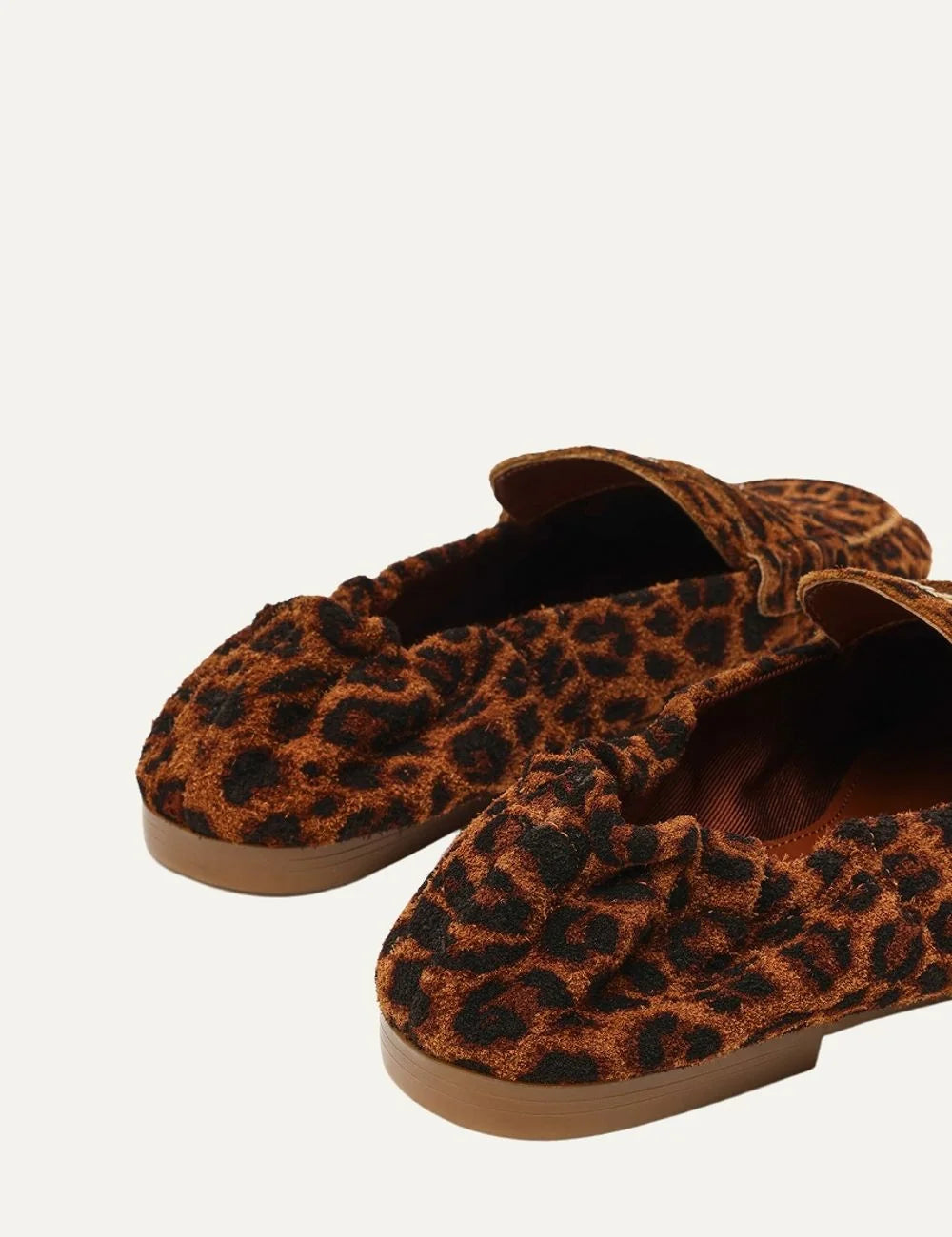 Steve Madden women's leopard print suede loafers in brown and black with decorative penny strap, gold tone metal detail, gathered heel, rounded toe and flat brown sole, back view