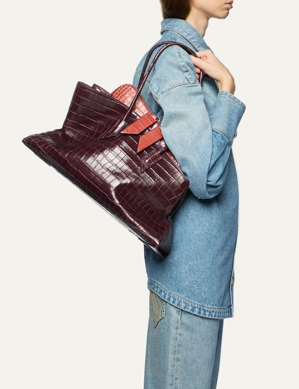 The Attico La Passeggiata Medium faded bordeaux crocodile print leather top handle bag for women on model