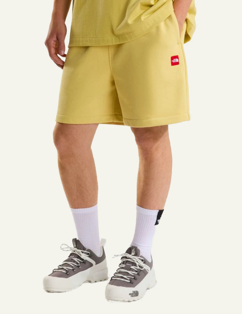 The North Face fleece shorts yellow honeyed sand front view elastic waist logo front model view
