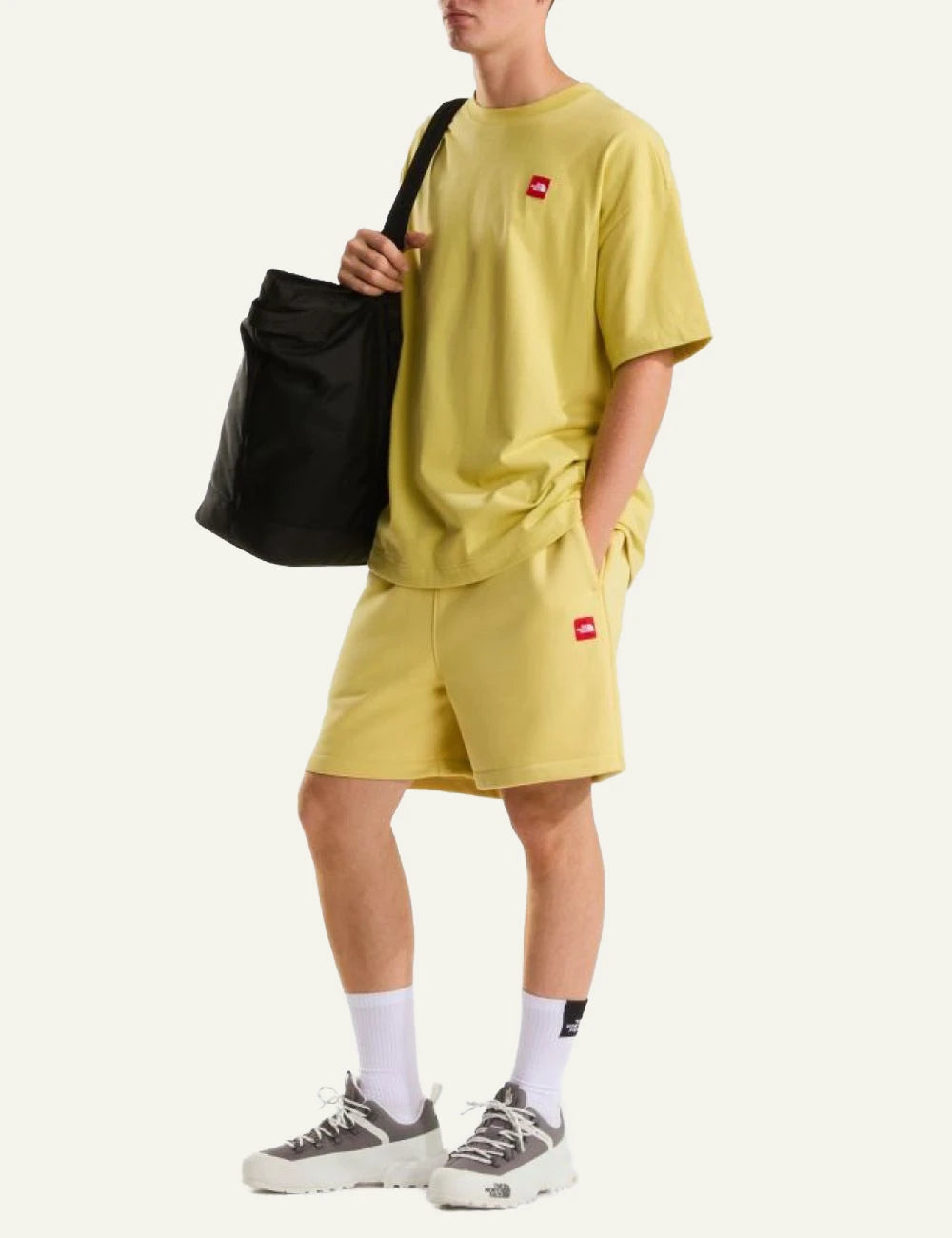 The North Face fleece shorts yellow honeyed sand front view elastic waist logo front full body view