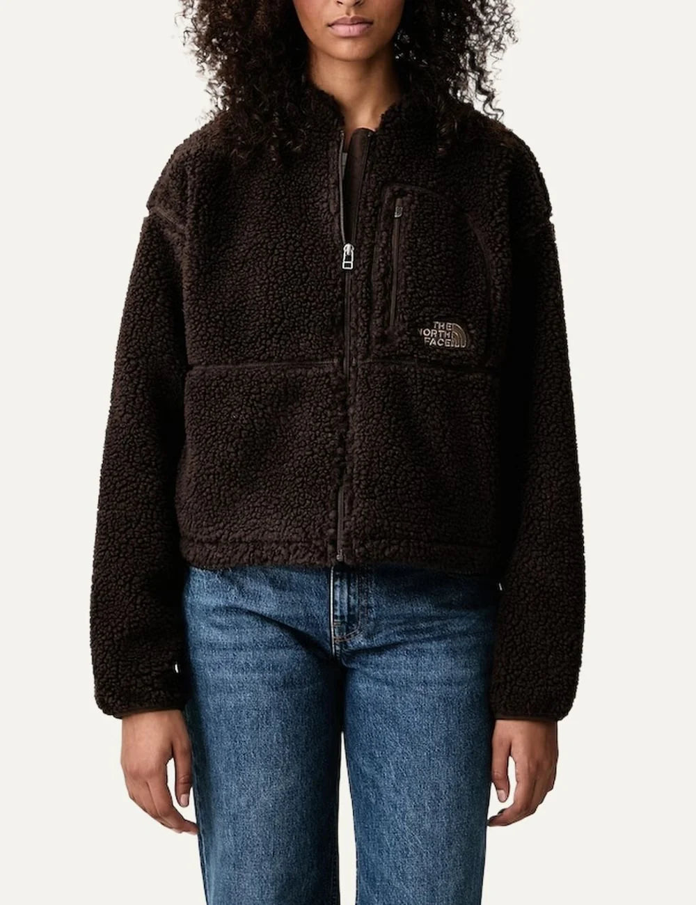 The North Face women's Extreme Pile dark brown cropped fleece jacket with textured sherpa fabric, high collar, front zipper and chest pocket.