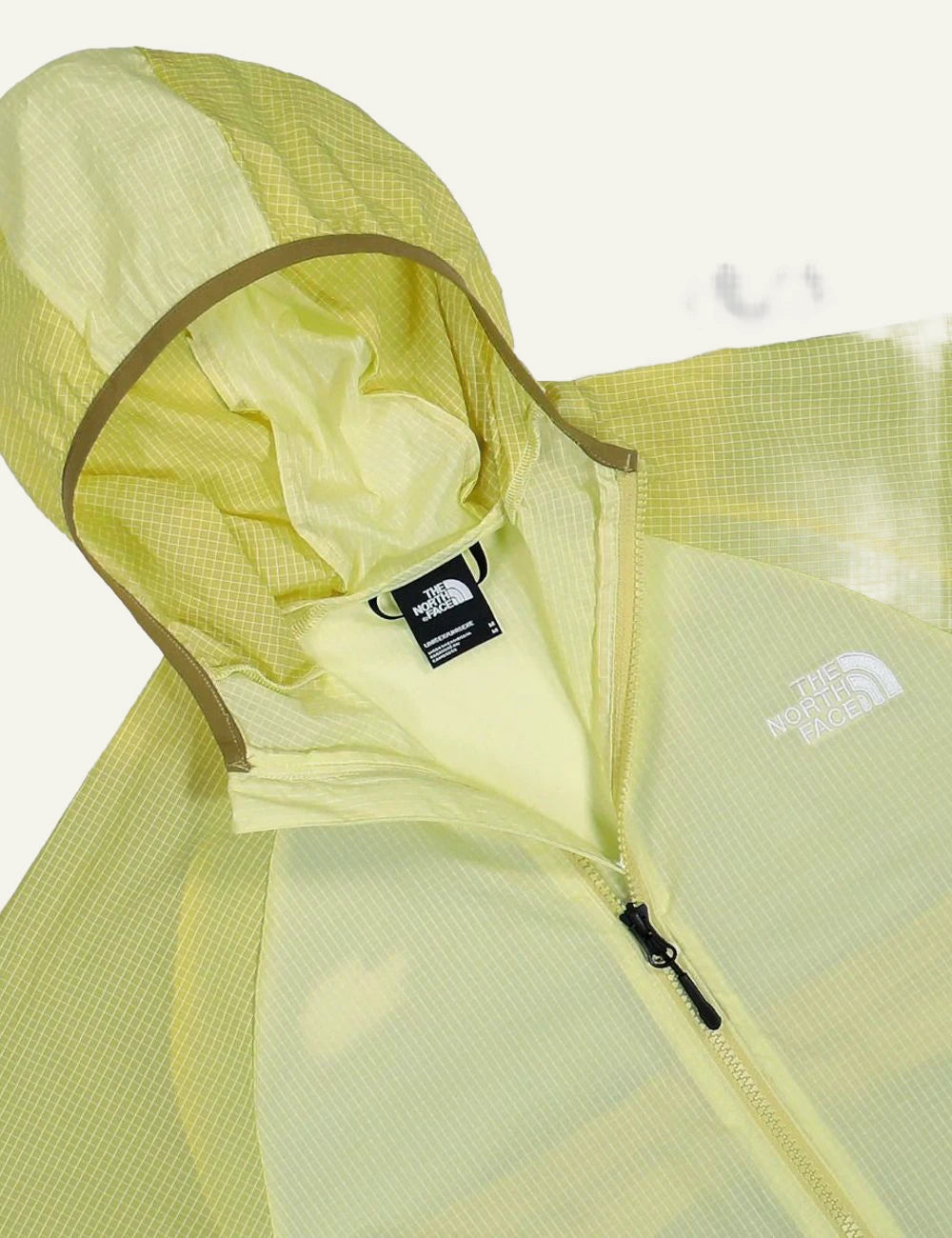 The North Face WindWall jacket yellow lightweight breathable hooded zip front detail view