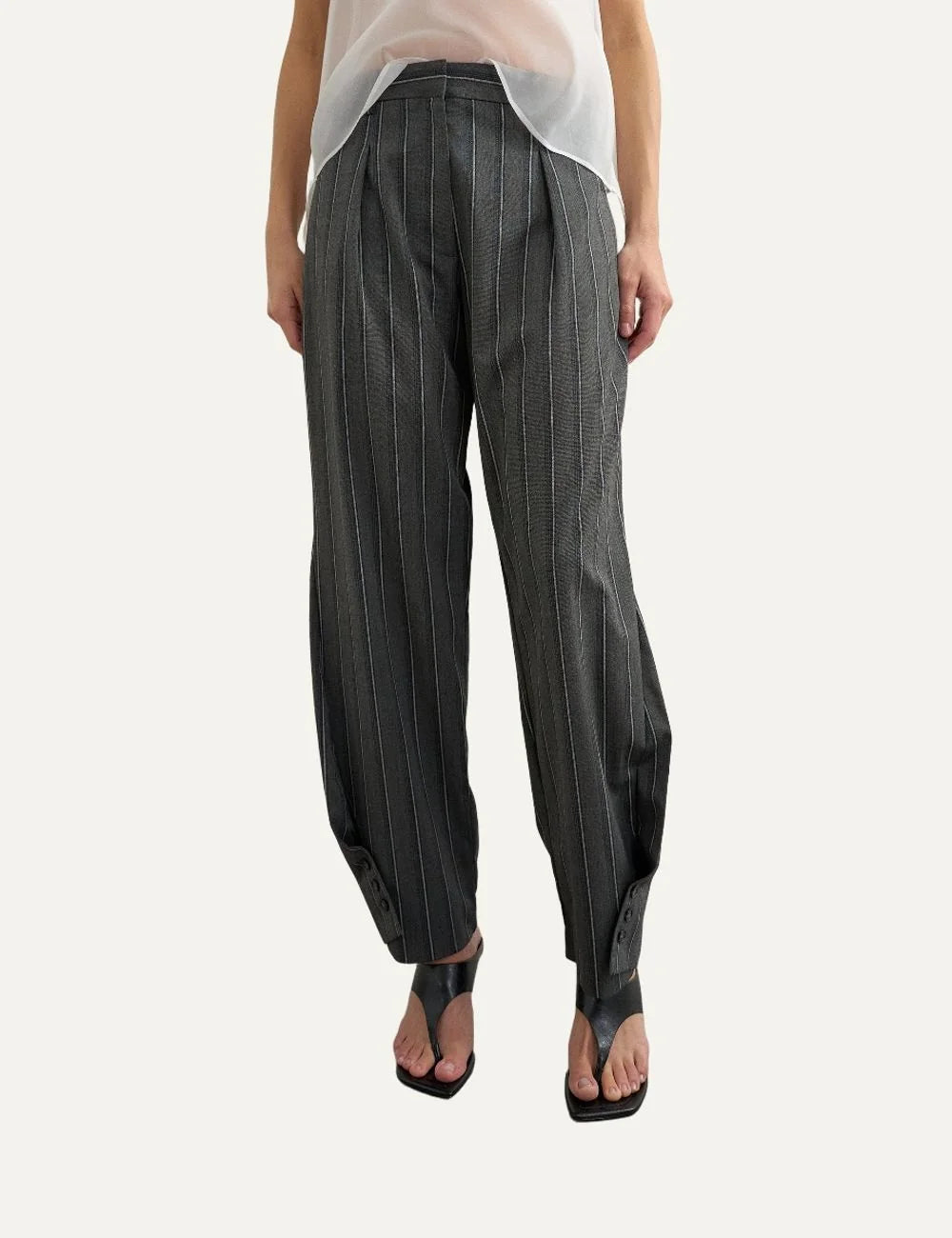 Topshop women's dark grey pinstripe straight-leg trousers with front pleats and button details at the hems model