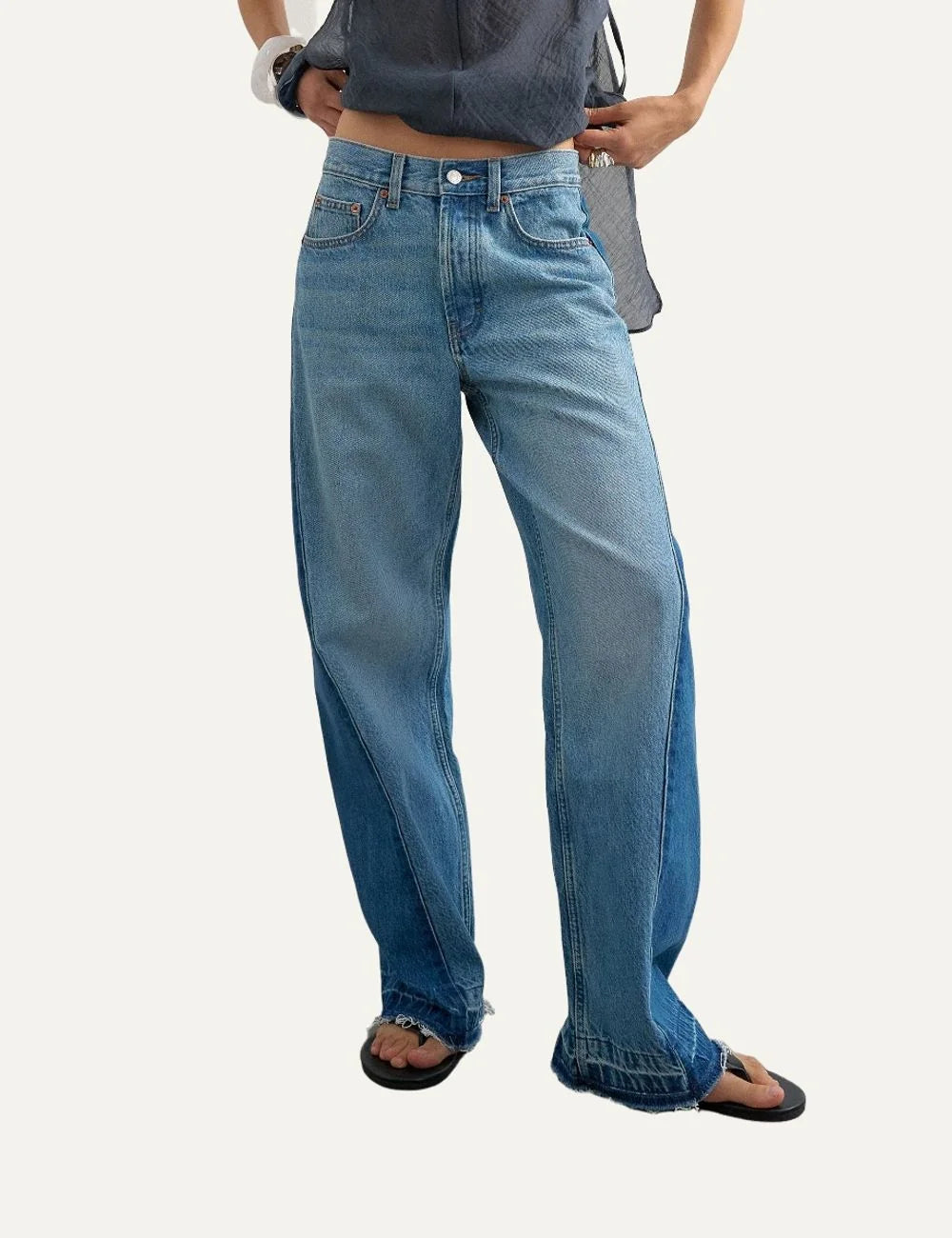 Topshop women's blue wide-leg jeans with contrasting dark blue side panels, faded wash and raw hems model