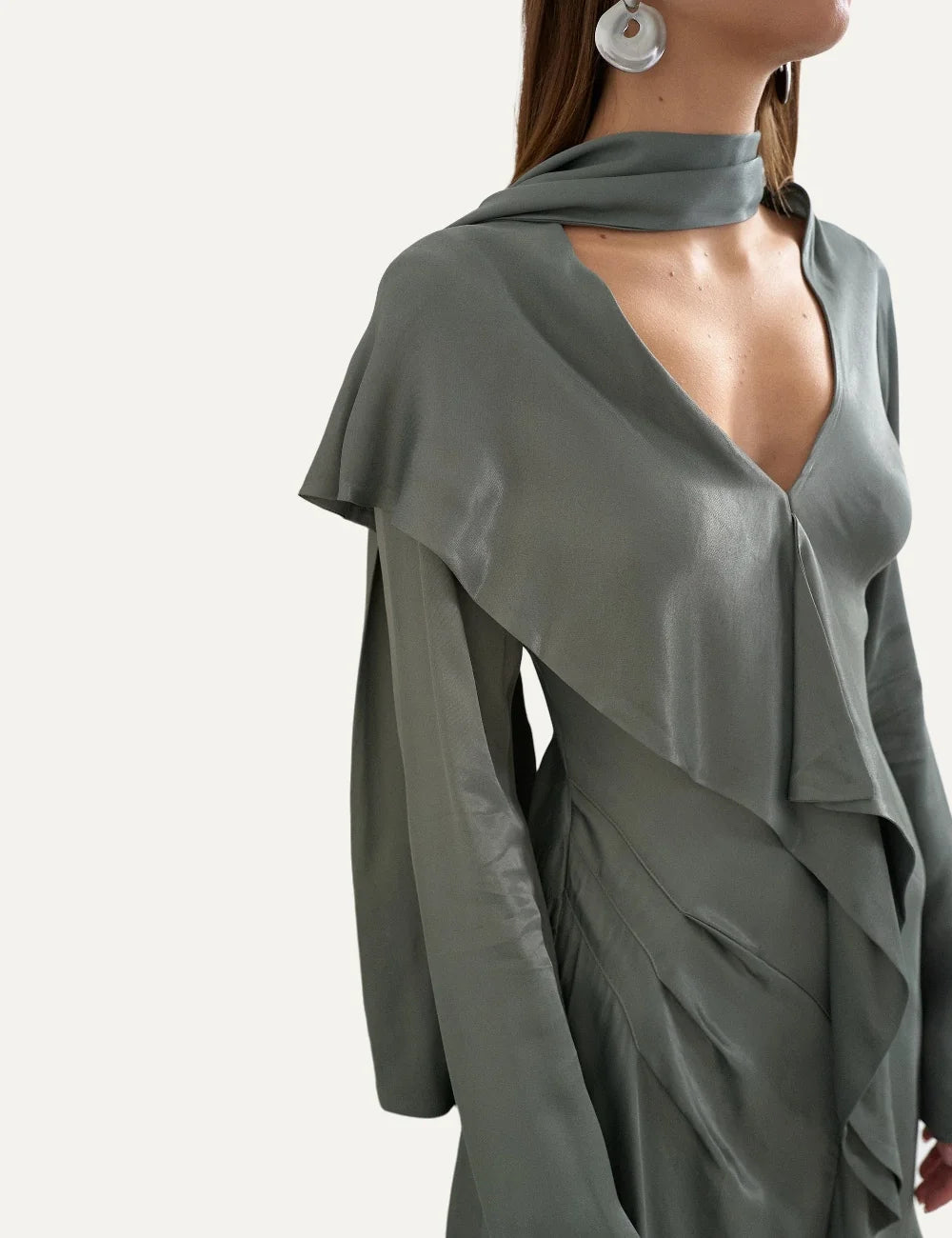 Topshop women's green satin mini dress with long sleeves, V-neckline, scarf detail and cascading front ruffles model