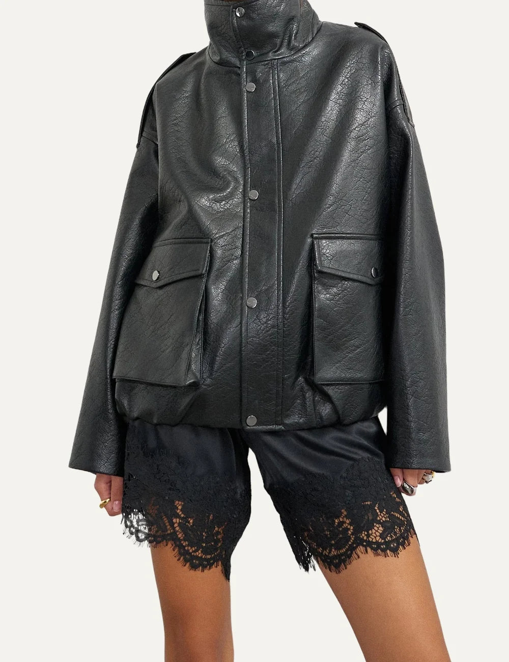 Topshop women's black faux leather bomber jacket with high stand collar, snap buttons and oversized flap pockets.