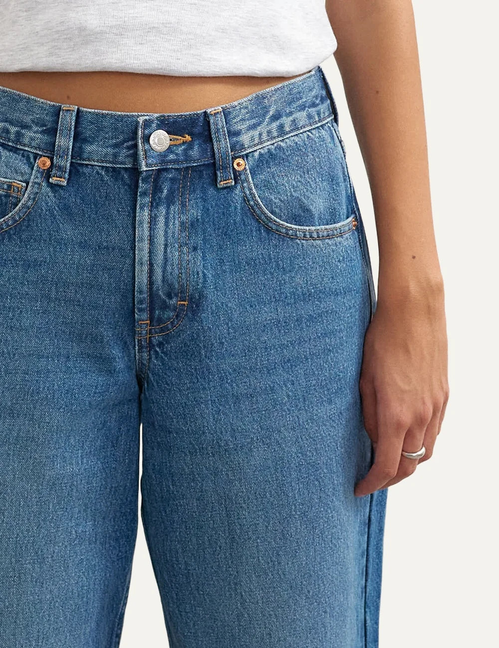 Topshop women's Cinch jeans in mid blue washed denim with a low-rise waist and relaxed straight legs detail