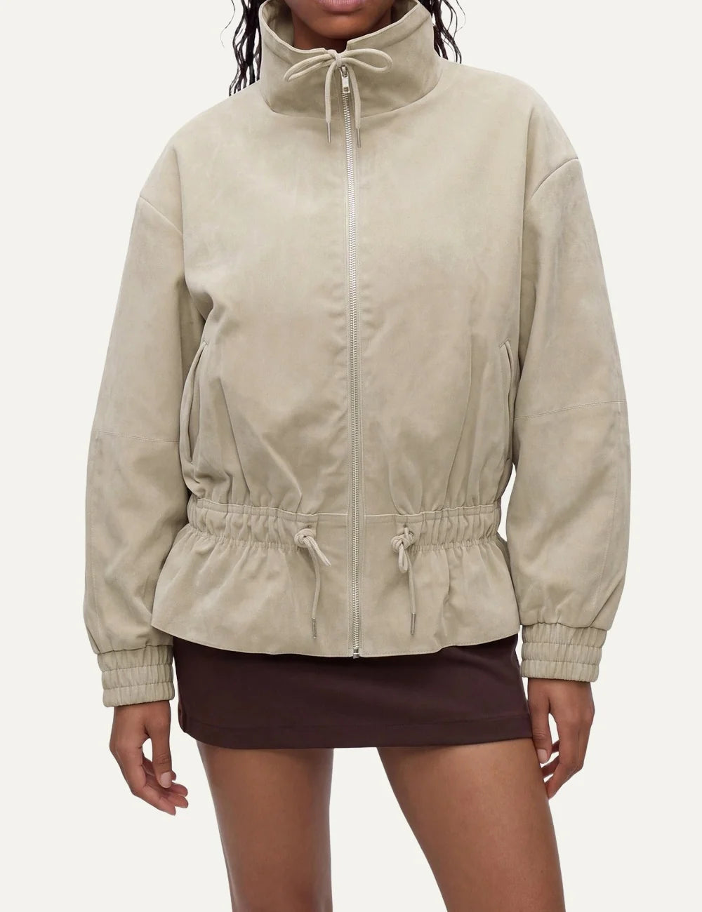 Topshop women's beige zip-up jacket with high collar, drawstring waist and elasticated cuffs model