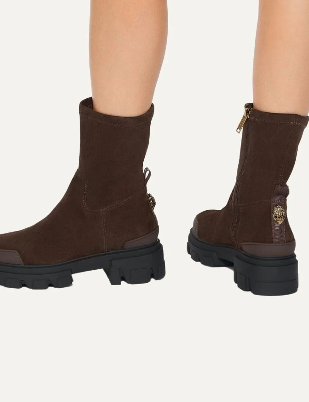 Kurt Geiger London Trail Sock Ankle dark brown suede ankle boots with soft shaft, gold eagle detail, side zipper and chunky black lug sole model