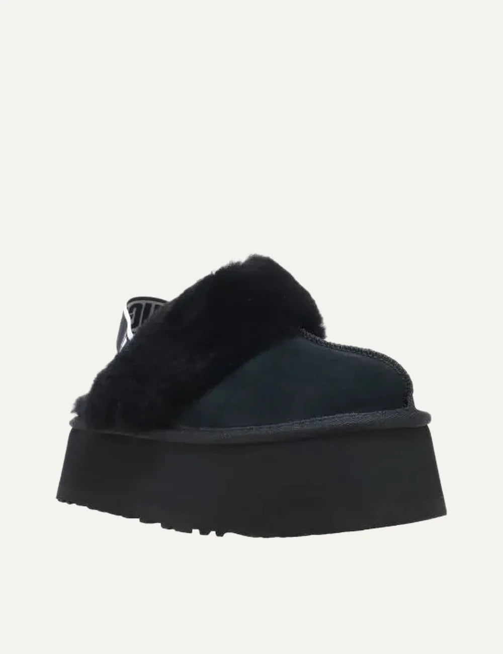 UGG black suede platform slippers with plush black fur trim, logo heel strap and chunky black sole angled