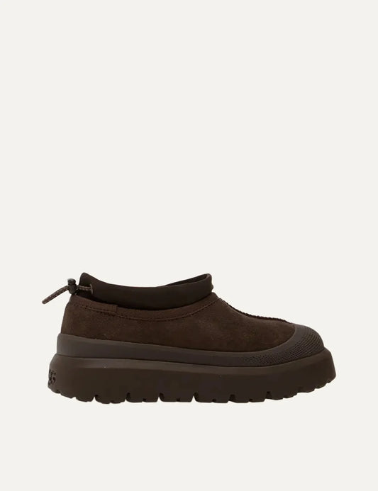 UGG men's dark brown suede slip-on shoes with drawcord collar, reinforced round toe and chunky lug sole.