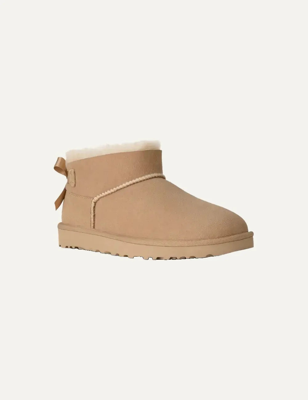 Women's UGG Bailey Bow Ultra Mini Sand boots with Twinface sheepskin, satin back bow and Sugarcane EVA sole angled