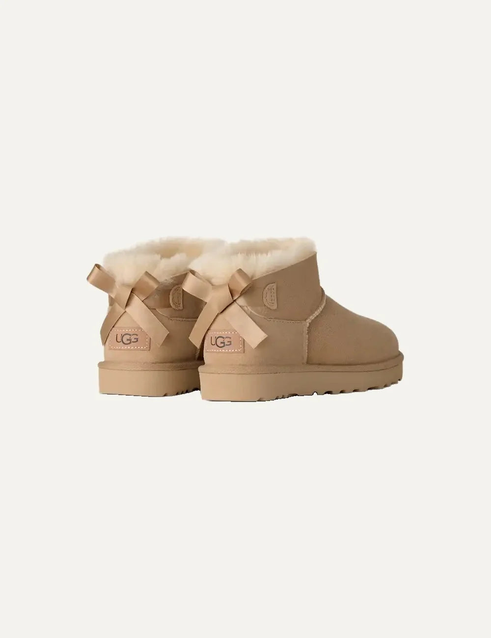 Women's UGG Bailey Bow Ultra Mini Sand boots with Twinface sheepskin, satin back bow and Sugarcane EVA sole back