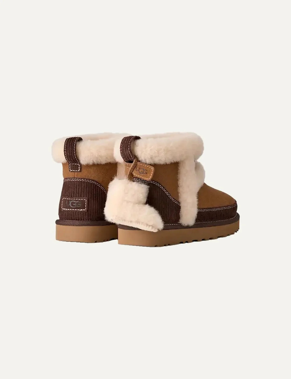 Women's UGG Classic Mini Heritage brown suede boots with sheepskin trim, removable boot charm, sheepskin lining and Sugarcane EVA outsole back