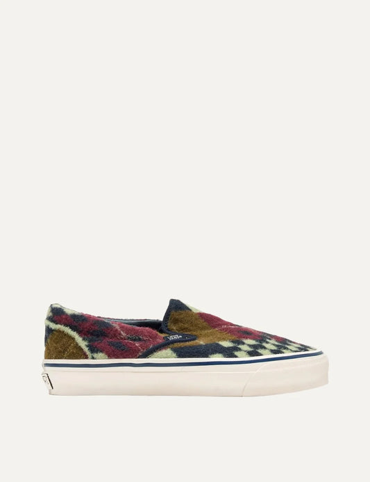 Vans LX Classic Slip-On 98 men's multicolor sneakers with textured wool-effect upper in burgundy, navy, brown and cream geometric patterns, elastic side panels and white rubber sole.