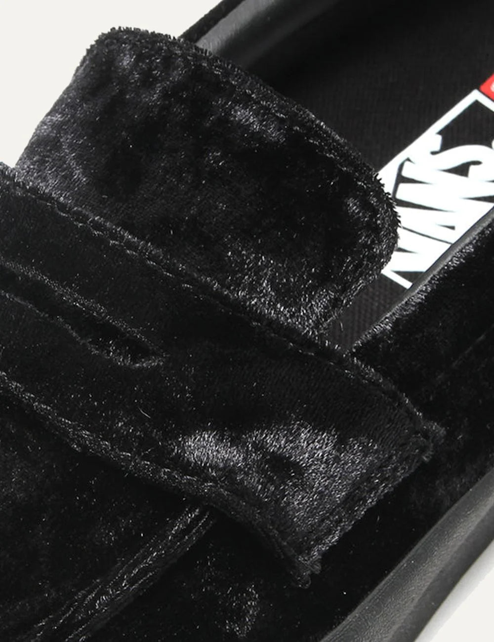 Vans Skate Loafer men's black velvet slip-on sneakers with classic loafer strap, low-profile silhouette and black vulcanized rubber waffle sole close up fabric detail