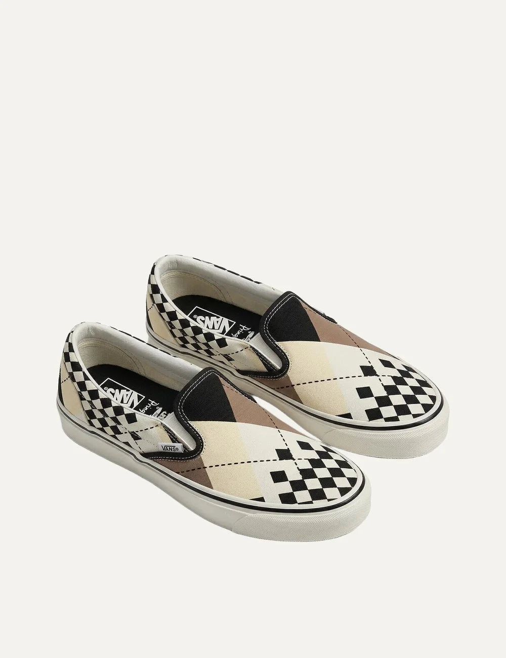 Vans x Pringle of Scotland unisex LX Classic Slip-On 98 sneakers in cream, black and beige, featuring mixed checkerboard and geometric patterns, elastic side panels and white rubber sole top view