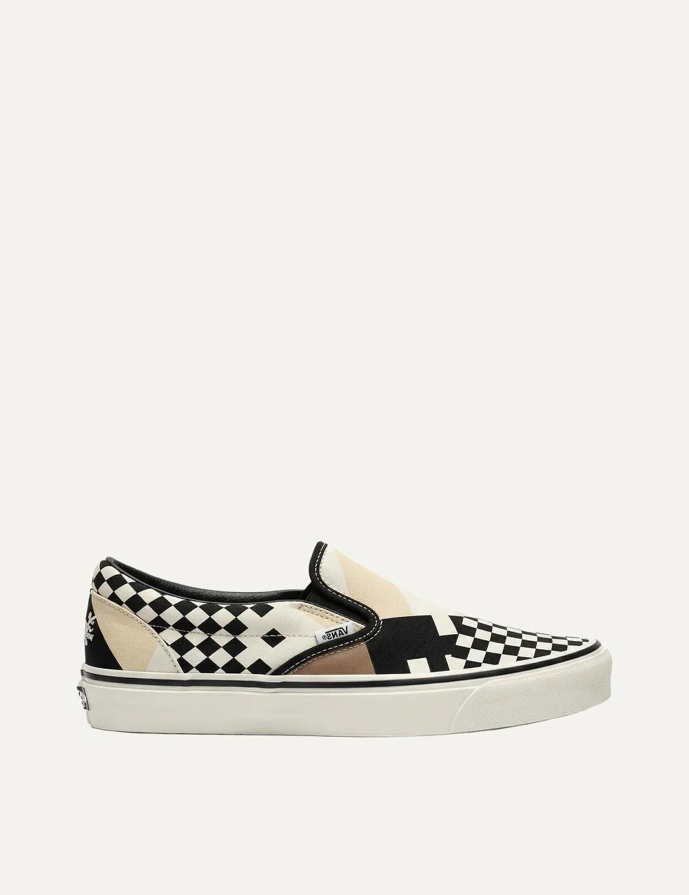 Vans x Pringle of Scotland unisex LX Classic Slip-On 98 sneakers in cream, black and beige, featuring mixed checkerboard and geometric patterns, elastic side panels and white rubber sole side view