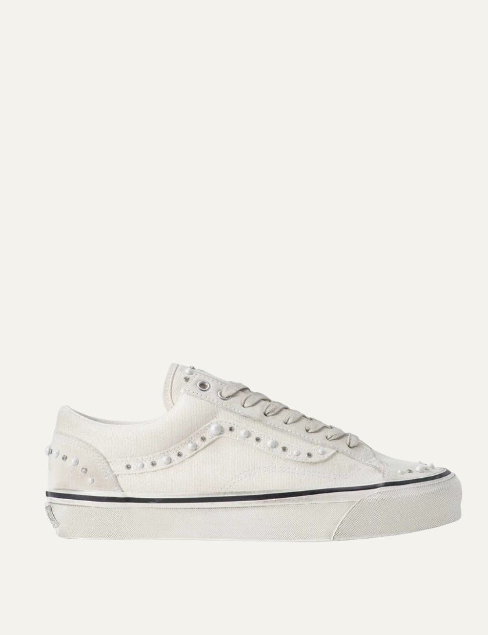White Vans low-top sneakers with suede and leather panels, pearl and silver stud embellishments, lace-up fastening and white rubber sole.