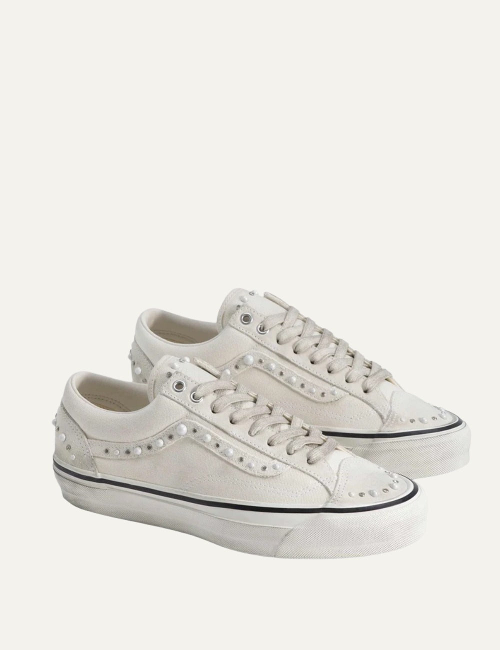 White Vans low-top sneakers with suede and leather panels, pearl and silver stud embellishments, lace-up fastening and white rubber sole profile