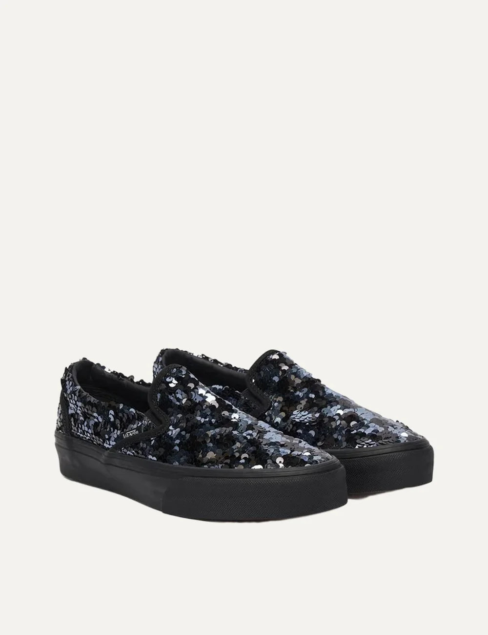 Vans Classic Slip-On women's black sneakers with black and silver sequins, elastic side panels and black rubber sole pair front angle view