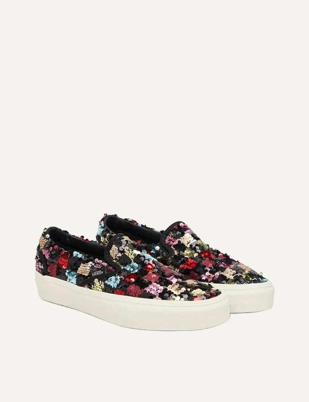 Vans Classic Slip-On women's sneakers in black with multicolored sequins, elastic side panels and white rubber sole pair front angle