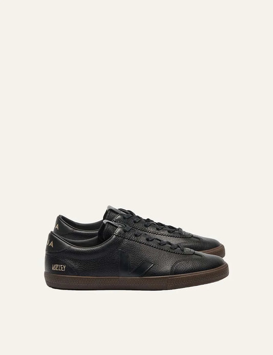 VEJA women's Volley Signature black leather sneakers with tonal V logo, gold branding, black laces and dark brown rubber sole.