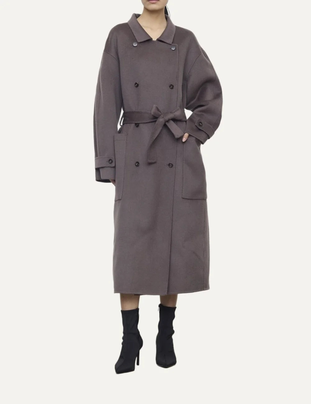 Women's grey brown oversized long double-breasted coat with shirt collar, matching waist belt and large patch pockets.