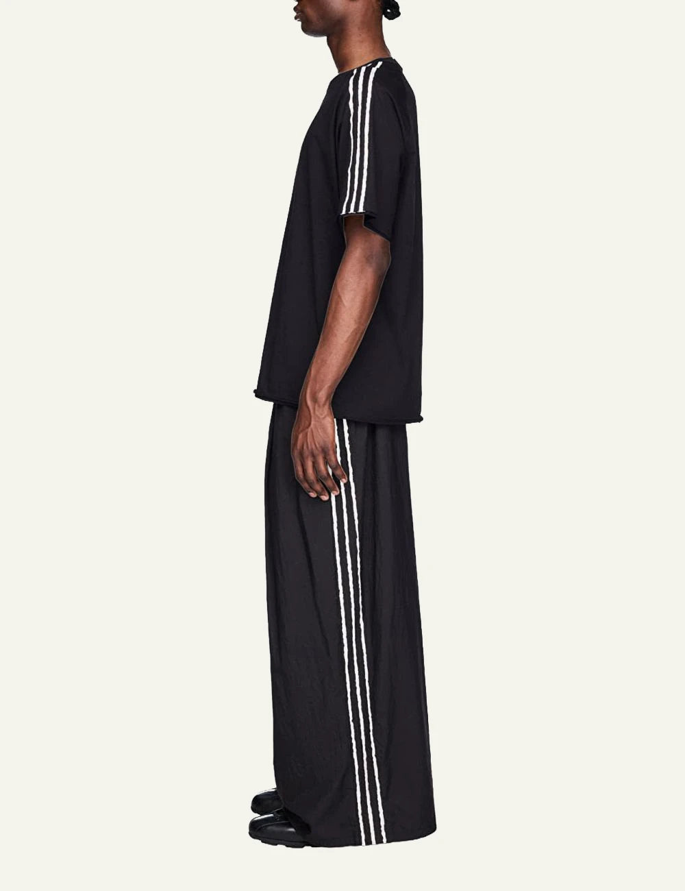 Y-3 wide leg track pants black three stripes front side view