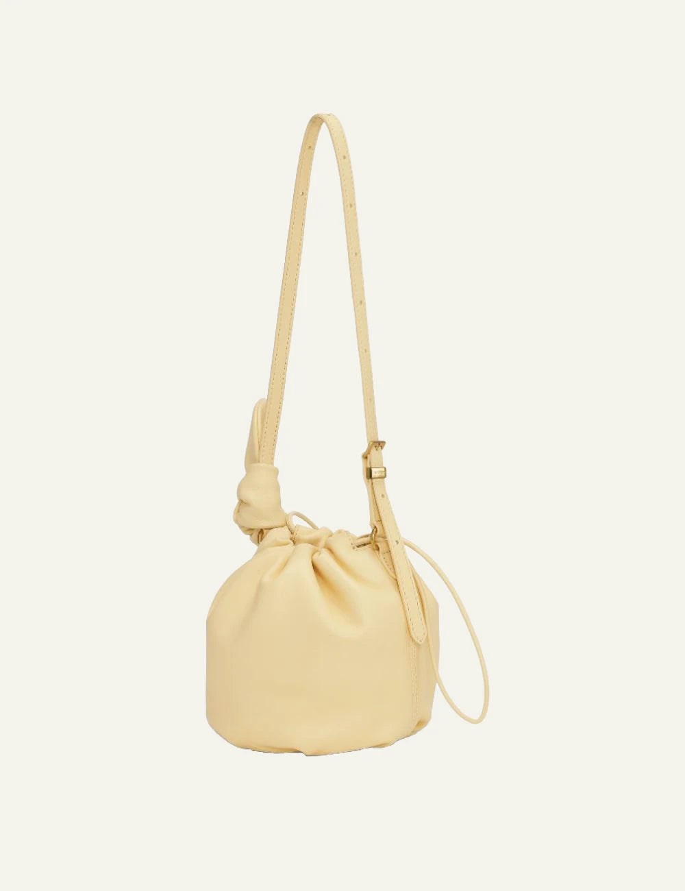 Yellow leather drawstring bucket bag with shoulder strap back flat view